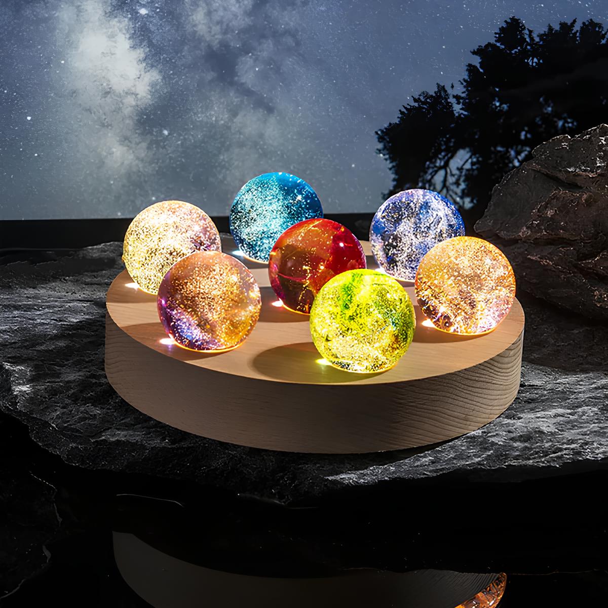 Set aus 7 leuchtenden Kristallkugeln mit Galaxie-Motiven auf Holzsockel